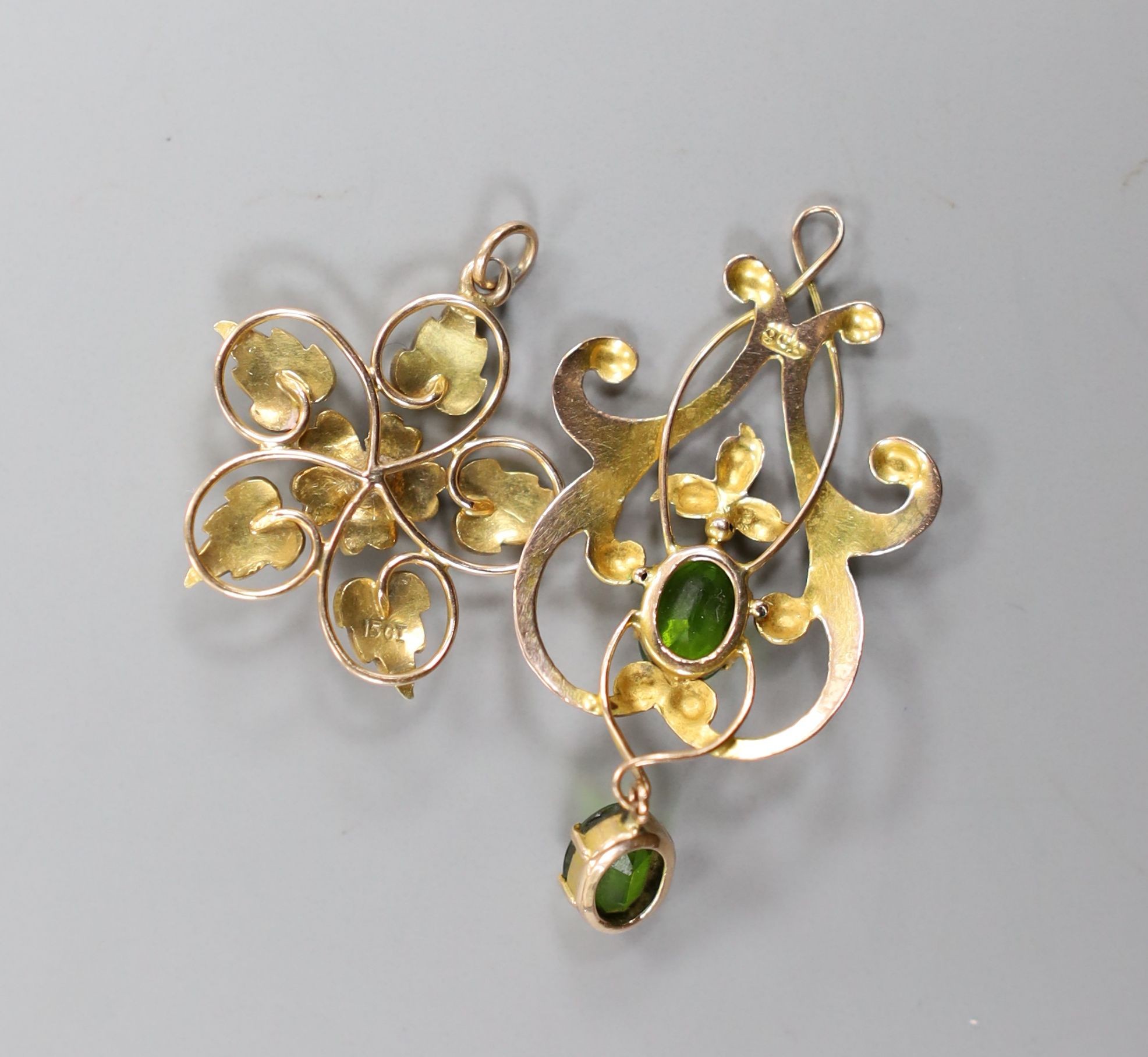 An early 20th century 9ct and green stone doublet set drop pendant, 41mm, gross 2 grams and a 15ct and seed pearl set pendant, gross 2.7 grams.